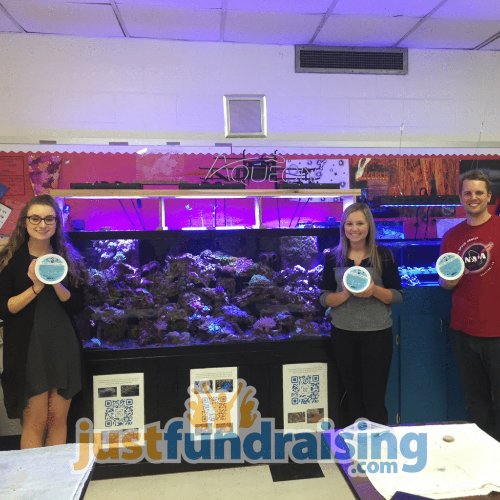 members of the saltwater reef club in front of aquarium