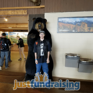 person doing the fundraiser next to a bear